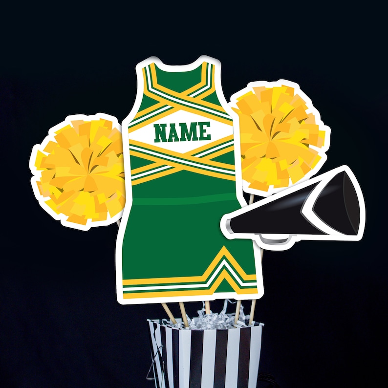 May include: Green and gold cheerleader outfit with a white name tag that says "NAME" on it. The outfit is surrounded by yellow pom-poms and a black megaphone.