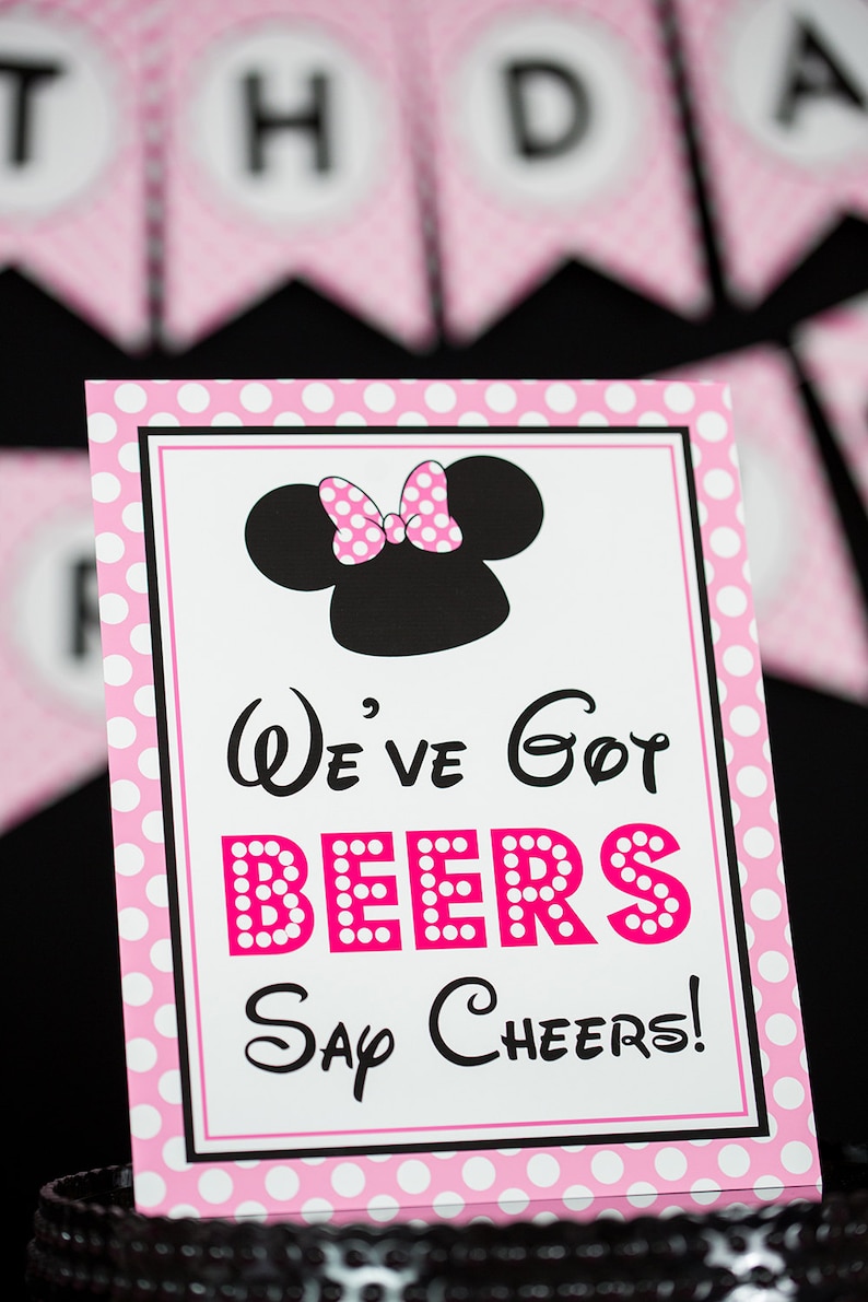 May include: Pink and white polka dot sign with a black and white image of Minnie Mouse. The sign says "We've got beers Say Cheers!"