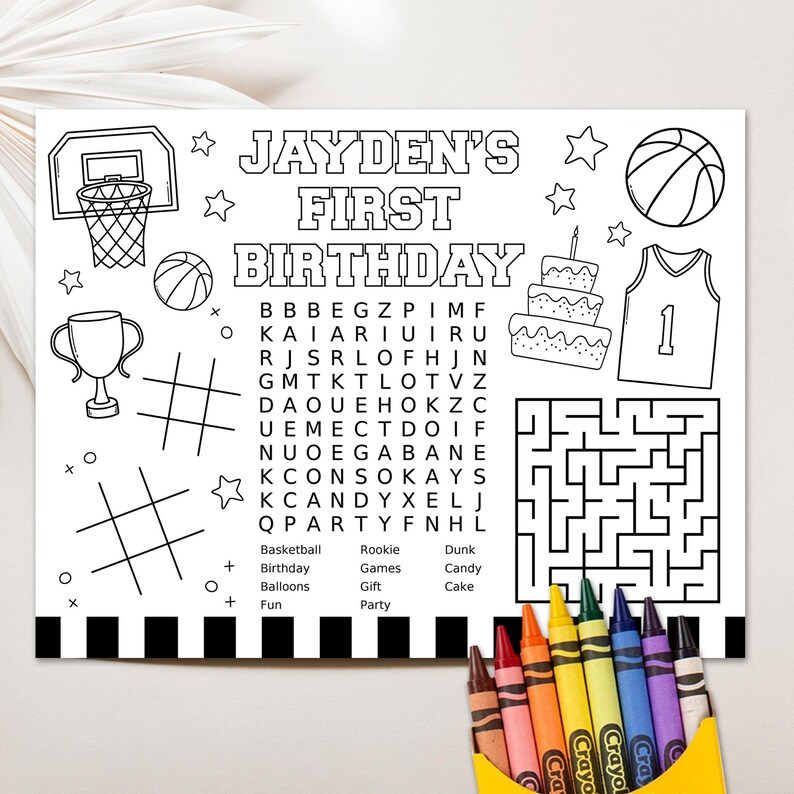 May include: A black and white printable coloring page for a child's first birthday party. The page features a basketball theme with a basketball hoop, basketballs, a basketball jersey, a cake, a trophy, a word search, and a maze. The text on the page reads "Jayden's First Birthday".