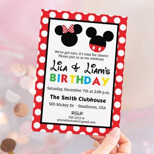 May include: A birthday invitation with a red polka dot border. The invitation features Mickey and Minnie Mouse silhouettes. Text includes "Lila & Liam's Birthday" and event details. The invitation is held by a person.