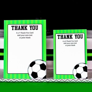 May include: Two green and white soccer-themed thank you cards with a soccer ball graphic. The larger card is 5 x 7 inches and the smaller card is 4 x 6 inches. Both cards have the text "Thank You" and instructions to add your own text or print blank.