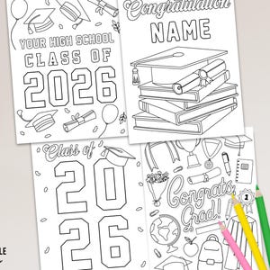 May include: Black and white graduation-themed coloring pages with the text "Your High School Class of 2026", "Class of 2026", and "Congrats Grad!". The pages feature graduation caps, diplomas, and balloons. Colored pencils are in the foreground.