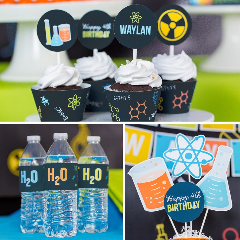 May include: A science-themed birthday party with cupcakes decorated with black and white cupcake wrappers with scientific symbols and topped with white frosting. The cupcakes have toppers with a beaker, a test tube, and a yellow and black radiation symbol. There is a water bottle with a black and blue label that says "H2O".