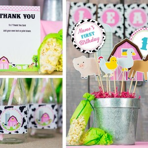 May include: Farm animal themed party decorations with a pink barn, a pig, a chicken, a duck, a horse, and a number one. The decorations are on sticks and are in a silver bucket. There are also bags of popcorn and milk bottles with straws.
