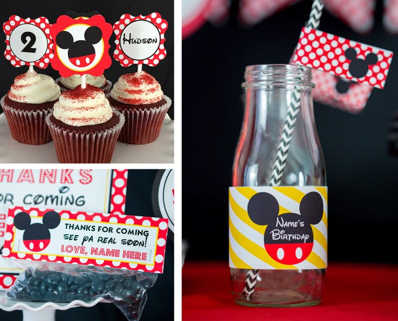 May include: Cupcakes with red and white frosting, topped with Mickey Mouse-themed decorations. A glass bottle with a yellow and white striped label and a Mickey Mouse design. Party favors with a Mickey Mouse theme.