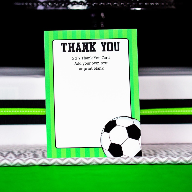 May include: A green and white soccer-themed thank you card with a soccer ball graphic. The card is 5 x 7 inches and has the text "THANK YOU" in bold black letters. The text below reads "5 x 7 Thank You Card Add your own text or print blank".