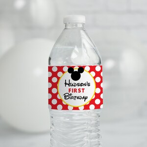 May include: Water bottle label with red and white polka dots, a yellow circle with the text "Hudson's First Birthday" and a black silhouette of Mickey Mouse's head.