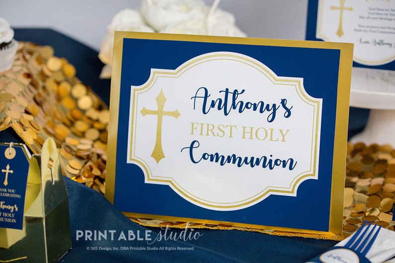 K&ouml;nnte beinhalten: Ein blaues und goldenes Tischschild mit einem wei&szlig;en Kreuz und dem Text "Anthony's First Holy Communion".
