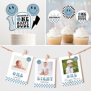 May include: A set of blue and black themed party decorations for a first birthday. The decorations include a cake topper with a smiley face, lightning bolt, and the text "Jackson's One Happy Dude", a banner with photos of a baby at different ages, and cupcake toppers with a smiley face and the text "One Happy Dude".