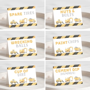 May include: Six white folded food tent cards with yellow and black diagonal hazard stripes at the top and bottom. Each card features watercolor illustrations of construction vehicles and text reading Spare Tires, Nuts & Bolts, Wrecking Balls, Paint Chips, Cup of Dirt, and Cement Dip (Hummus).