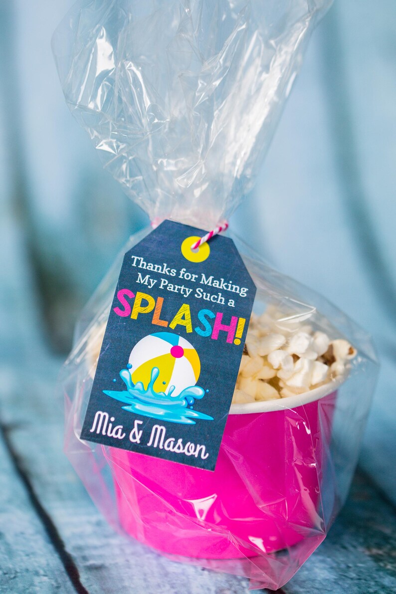 May include: A pink and white popcorn container with a thank you tag that says "Thanks for Making My Party Such a SPLASH! Mia & Mason". The tag has a blue and yellow beach ball graphic.