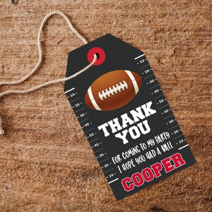 May include: Black and white thank you tag with a red circle at the top. The tag features a football graphic and the text "Thank You for coming to my party I hope you had a ball Cooper".