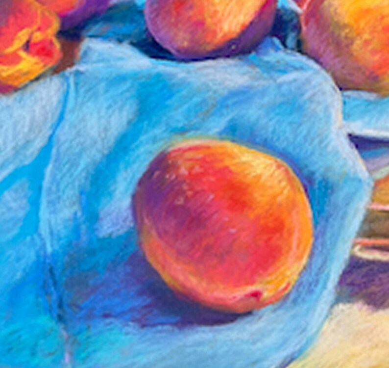May include: A close-up of a single peach resting on a blue cloth. The peach is a vibrant orange-red color with a slight purple hue. The cloth is a soft, textured blue with a slight purple tint.