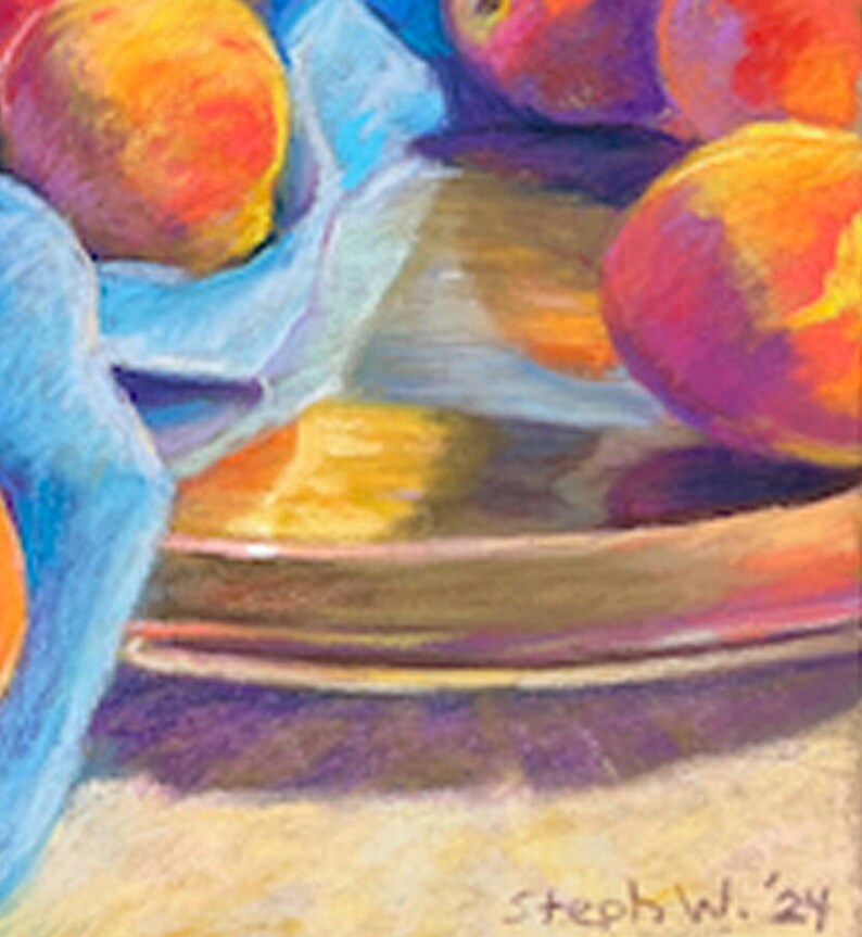 May include: A still life painting of peaches in a bowl with a blue cloth draped over the side. The peaches are a vibrant orange and red, and the bowl is a dark brown. The painting is signed "Steph W. '24" in the bottom right corner.