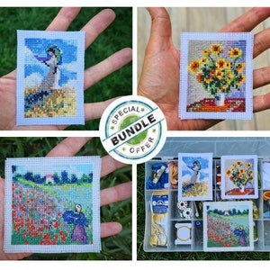 May include: A set of four cross-stitch patterns featuring a woman with an umbrella, a bouquet of sunflowers, and a field of poppies. The patterns are displayed on white fabric and are ready to be stitched. The image also includes a plastic storage box with various embroidery supplies.