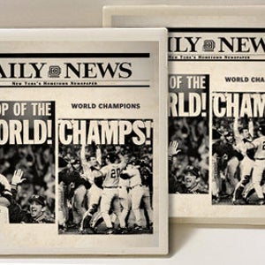 May include: Two vintage-style newspaper clippings with the headline "DAILY NEWS" and the text "TOP OF THE WORLD! CHAMPS!" and "WORLD CHAMPIONS". The clippings feature a baseball team celebrating a victory.