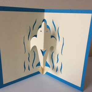 Tarjeta emergente de delfines