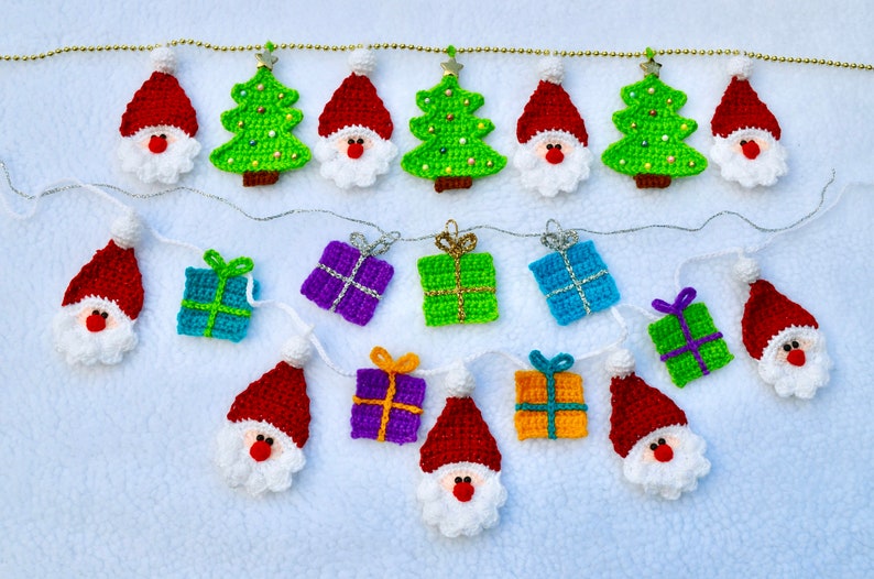 May include: A Christmas garland with crocheted ornaments. The garland features Santa Claus, Christmas trees, and presents in various colors, including red, green, blue, purple, and orange.