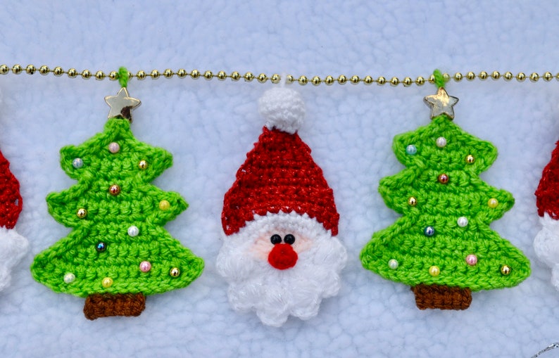 May include: A crocheted Christmas garland with green trees, a Santa Claus, and gold beads.