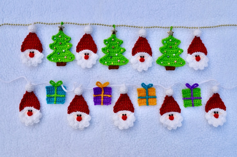 May include: A Christmas garland with crocheted ornaments. The garland features red Santa Claus figures, green Christmas trees, and blue, purple, and yellow gift boxes.
