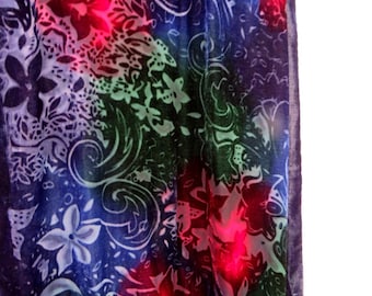 May include: A velvet scarf featuring a dark blue and purple base with a vibrant floral and swirling pattern. The design includes bright pink highlights on the flower petals and intricate white line work throughout the fabric surface.