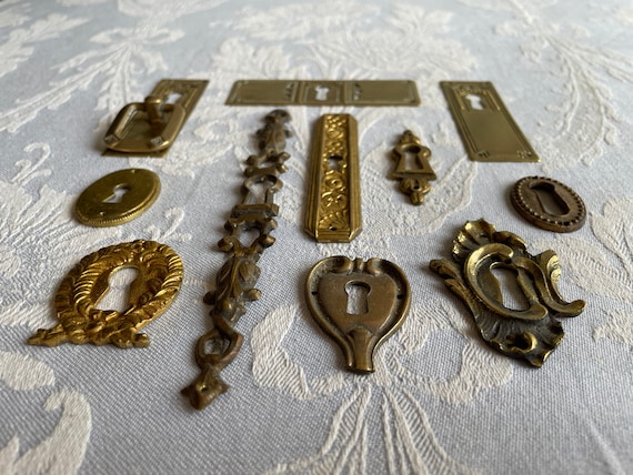 various styles of antique brass keyhole escutcheons