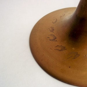 A 12" tall brass goblet.
This is a vintage brass goblet with a leaf etched design around the bowl and the base. 
The bottom of the goblet bowl is not smooth and the bottom goes into the stem a little bit so it's not recommended to drink out of it. 
Great for many styles of décor such as bohemian, farmhouse, romantic or cottage.  
approx. 
12" Tall
4 1/2-3/4" at widest point
3 3/4" opening
4 1/2" depth
base is 4 3/4" diameter
3/8" width at middle of stem
India is etched on bottom