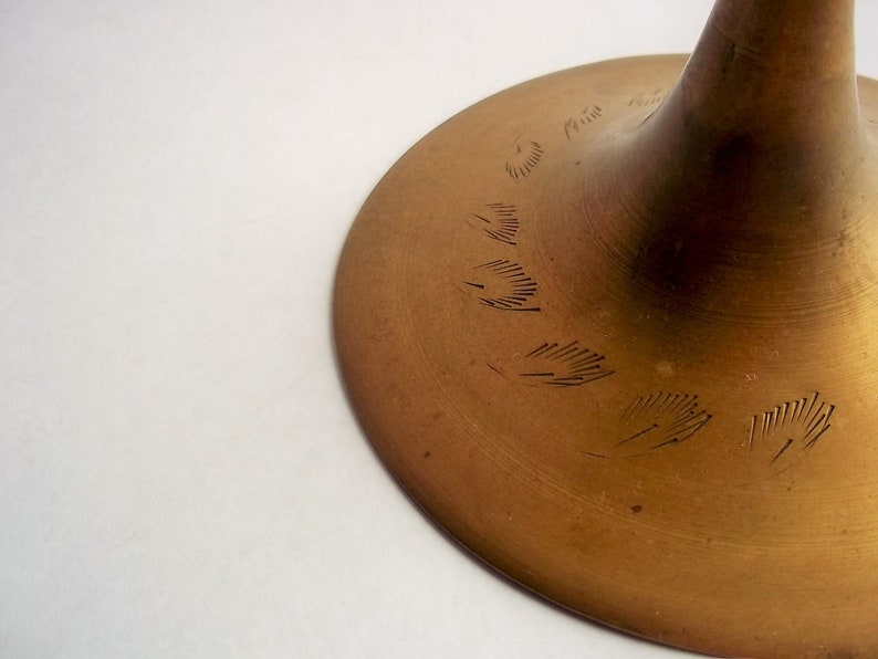 A 12" tall brass goblet.
This is a vintage brass goblet with a leaf etched design around the bowl and the base. 
The bottom of the goblet bowl is not smooth and the bottom goes into the stem a little bit so it's not recommended to drink out of it. 
Great for many styles of décor such as bohemian, farmhouse, romantic or cottage.  
approx. 
12" Tall
4 1/2-3/4" at widest point
3 3/4" opening
4 1/2" depth
base is 4 3/4" diameter
3/8" width at middle of stem
India is etched on bottom