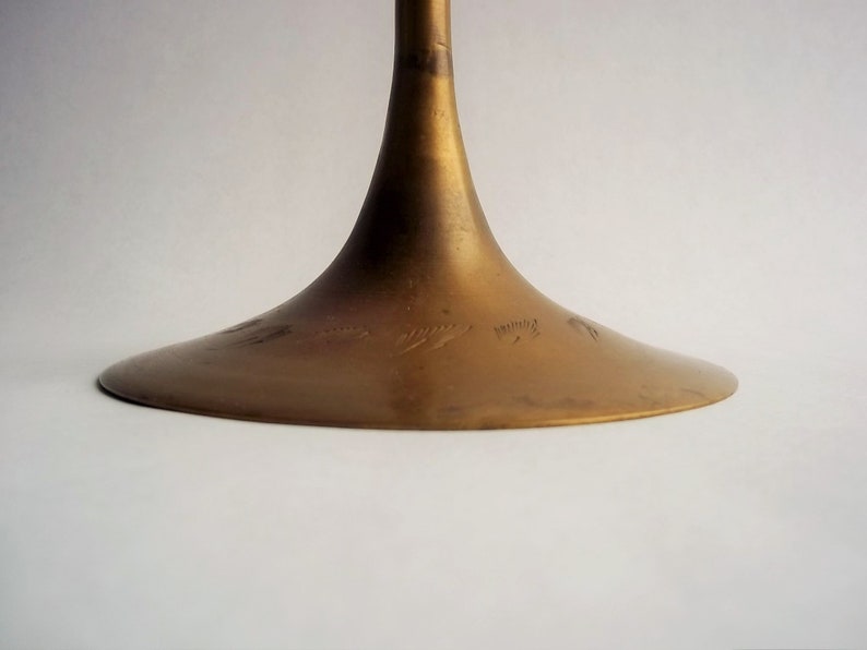 A 12" tall brass goblet.
This is a vintage brass goblet with a leaf etched design around the bowl and the base. 
The bottom of the goblet bowl is not smooth and the bottom goes into the stem a little bit so it's not recommended to drink out of it. 
Great for many styles of décor such as bohemian, farmhouse, romantic or cottage.  
approx. 
12" Tall
4 1/2-3/4" at widest point
3 3/4" opening
4 1/2" depth
base is 4 3/4" diameter
3/8" width at middle of stem
India is etched on bottom