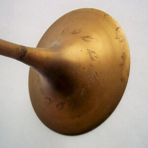 A 12" tall brass goblet.
This is a vintage brass goblet with a leaf etched design around the bowl and the base. 
The bottom of the goblet bowl is not smooth and the bottom goes into the stem a little bit so it's not recommended to drink out of it. 
Great for many styles of décor such as bohemian, farmhouse, romantic or cottage.  
approx. 
12" Tall
4 1/2-3/4" at widest point
3 3/4" opening
4 1/2" depth
base is 4 3/4" diameter
3/8" width at middle of stem
India is etched on bottom