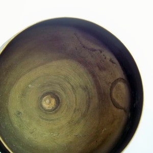 A 12" tall brass goblet.
This is a vintage brass goblet with a leaf etched design around the bowl and the base. 
The bottom of the goblet bowl is not smooth and the bottom goes into the stem a little bit so it's not recommended to drink out of it. 
Great for many styles of décor such as bohemian, farmhouse, romantic or cottage.  
approx. 
12" Tall
4 1/2-3/4" at widest point
3 3/4" opening
4 1/2" depth
base is 4 3/4" diameter
3/8" width at middle of stem
India is etched on bottom