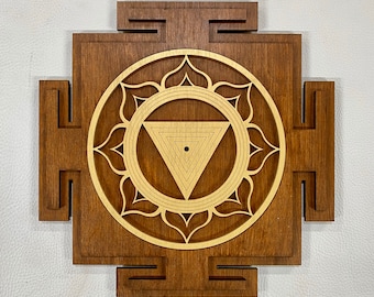 May include: A wooden square yantra with a carved mandala design in gold. The mandala features a triangle with a dot in the center.