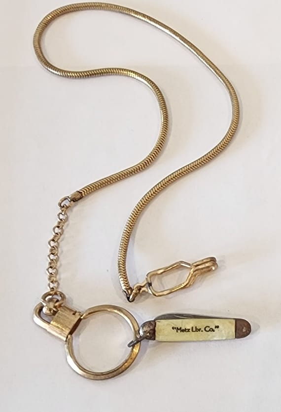 Vintage, antique pocket watch chain with a pocket 