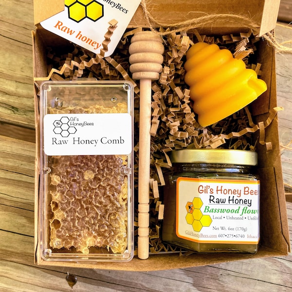 Comb honey gift box with pure honey jar, honeycomb, beeswax candle, and wooden honey dipper