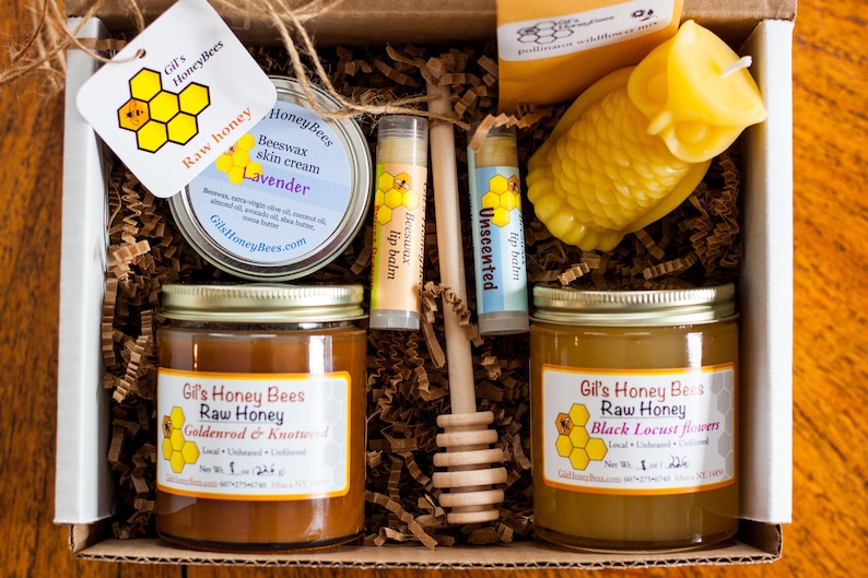 Raw honey gift basket with a beeswax candle, natural skin salve, 2 lip balms. wooden honey dipper, and a bag of pollinators wildflower seed mix