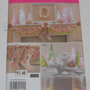 May include: A Simplicity sewing pattern for making Christmas decorations. The pattern includes instructions for making a variety of festive items, including stockings, trees, and a garland. The pattern is priced at $17.95.