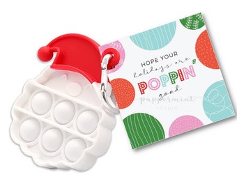 Puede incluir: Etiqueta de regalo de Navidad imprimible con un diseño colorido y el texto "Espero que tus vacaciones sean poppin' good". La etiqueta está diseñada para ser adjuntada a un juguete pop it.