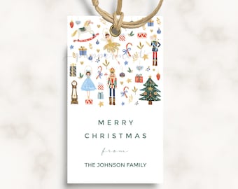 May include: A white gift tag with a colorful illustration of a nutcracker, a ballerina, a rocking horse, a Christmas tree, and other holiday decorations. The text "Merry Christmas from The Johnson Family" is printed on the tag.