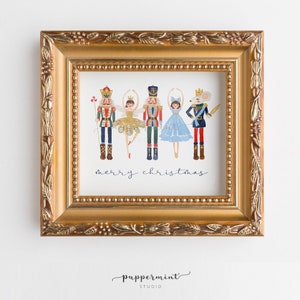 May include: A framed illustration of a Nutcracker and a ballerina with the text "merry christmas". The illustration is in a gold frame with a decorative border.