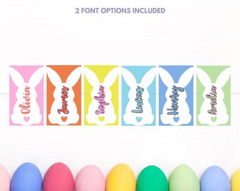May include: Six colorful Easter bunny gift tags with names printed on them. The tags are pink, orange, yellow, blue, light blue, and green. The names on the tags are Olivia, James, Sophia, Lucas, Henry, and Amelia.