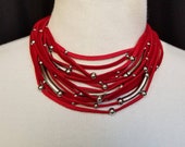 Multi Strand Red Leather necklace with stainless steel bars and beads.