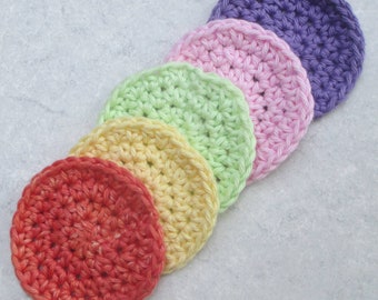 May include: Six crocheted cotton rounds in a rainbow of colors, from red to purple. The rounds are arranged in a line, with the red round at the bottom and the purple round at the top.