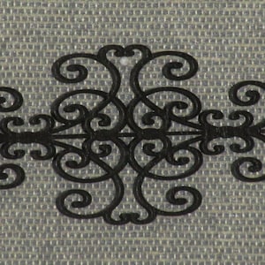 May include: Black metal wall decor with a decorative, ornate design. The design features a series of swirls and curves.