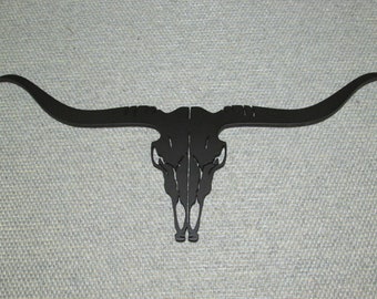 May include: Black metal longhorn skull wall decor with large horns.