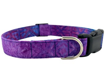 May include: Purple and blue patterned dog collar with a black plastic buckle and a silver metal D-ring.