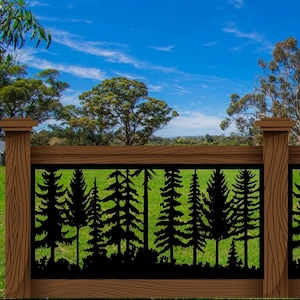 May include: A wooden fence with a decorative black metal panel featuring a silhouette of a forest scene. The fence is brown with a natural wood grain, set against a backdrop of green grass and a blue sky with clouds.