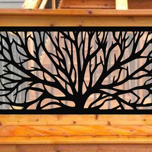 May include: Black metal decorative panel featuring a tree branch design. The panel is rectangular and is set against a wooden deck railing. The tree branches are intricately cut out, creating a silhouette.