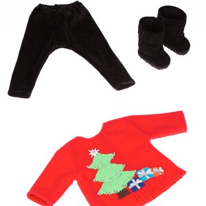 May include: A red Christmas sweater with a green Christmas tree and presents on the front. The sweater has a fringe trim. The sweater is paired with black leggings and black boots.