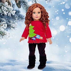May include: A red Christmas sweater with a green felt Christmas tree and colorful felt presents. The sweater has a fringed hem and is worn by a doll with long curly red hair.