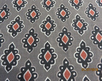 May include: A gray fabric with a repeating pattern of black and red diamond shapes. The fabric has a subtle texture.
